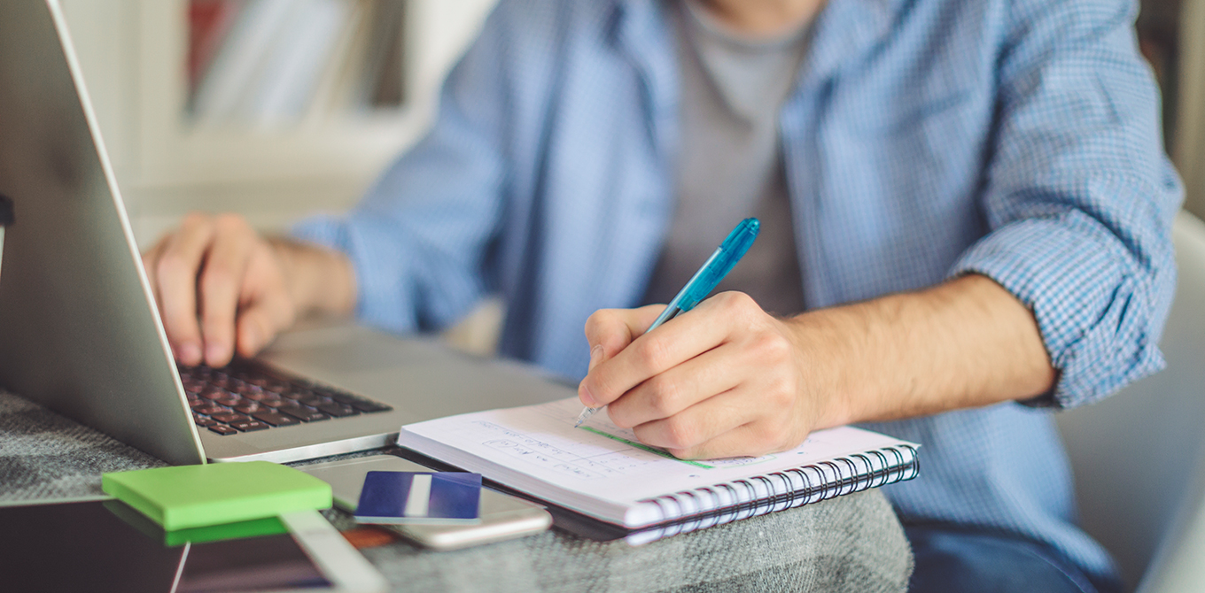 Man writing in notebook